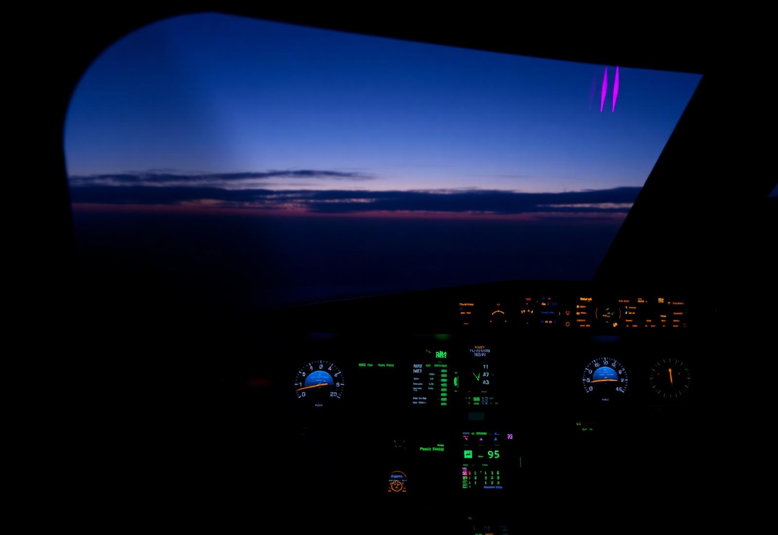Cockpit at dusk with glowing navigation displays